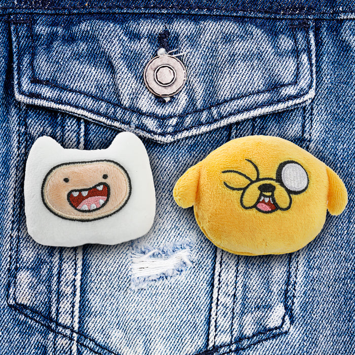 Adventure Time plush pins featuring Jake and Finn character designs in a 2-pack, ideal for collecting or displaying.