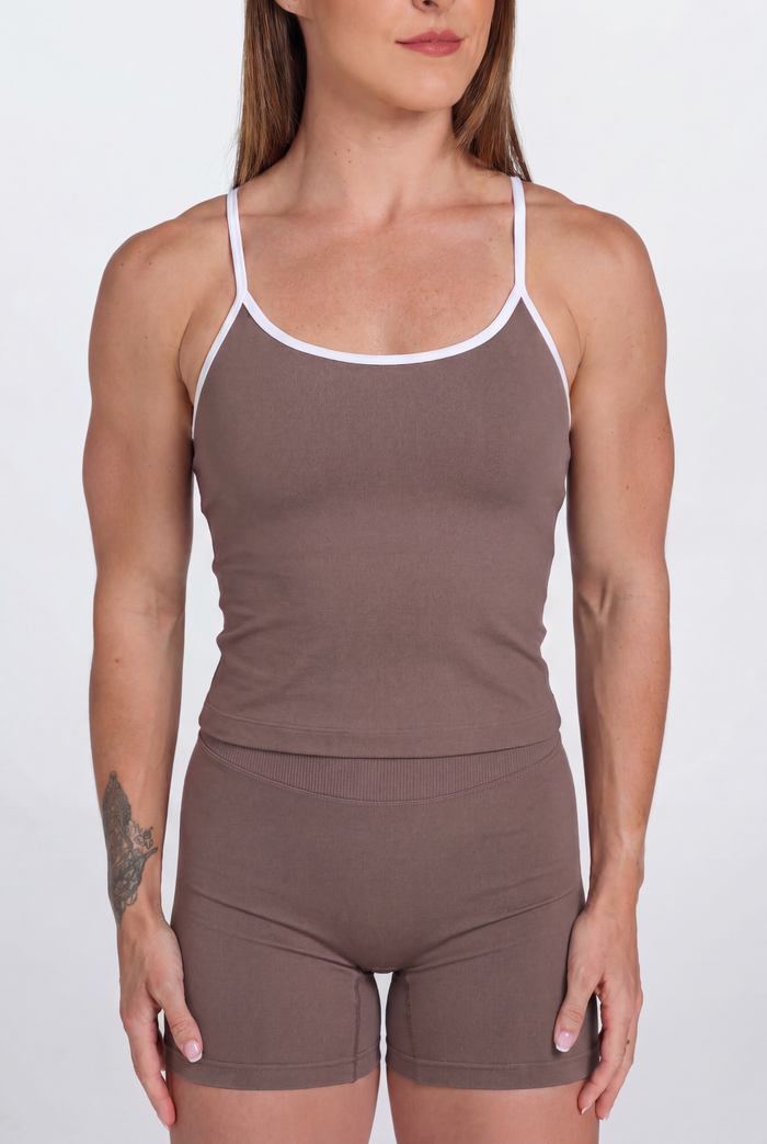 Woman wearing a Mocha tank top and shorts set with white trim on a white background