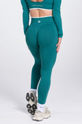 High waisted seamless gym tights, with textured booty sculpting panels, and a luxe white trim, in teal colour.