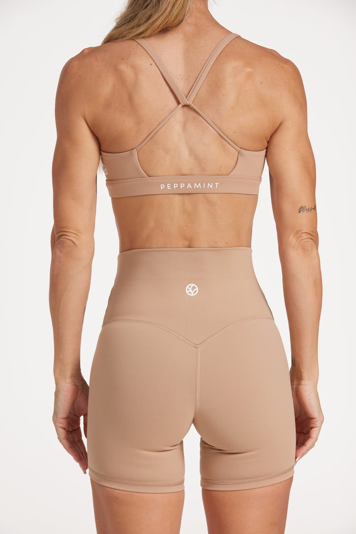 high waisted gym shorts, in buttery soft, supportive fabric with 6 inch inseam and no front rise seam, in a light taupe colour
