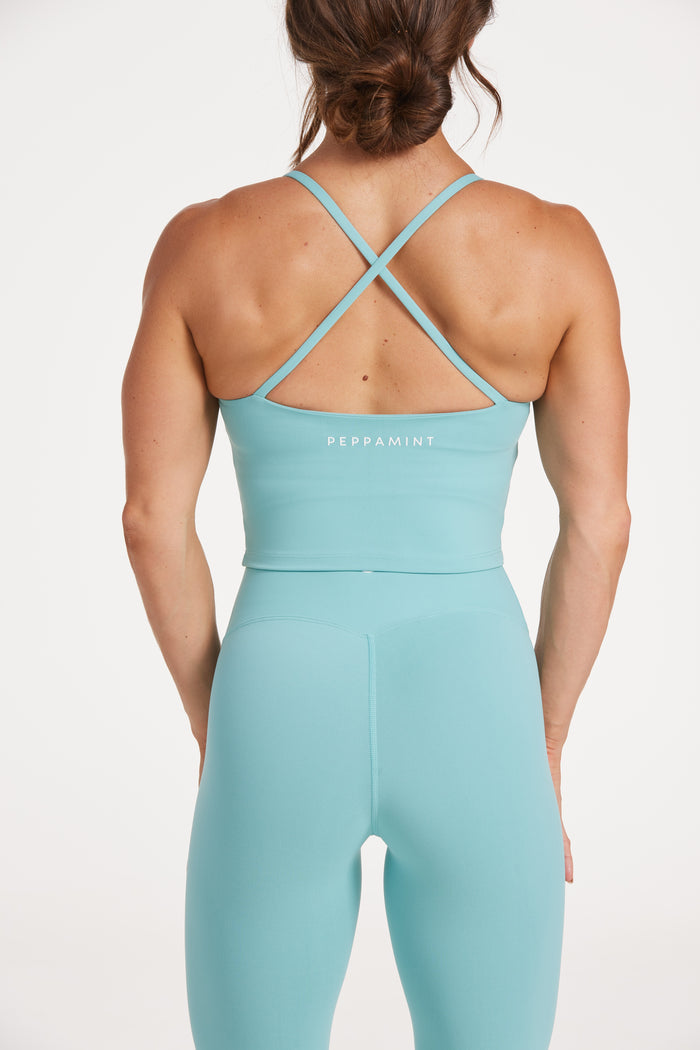 crop singlet with thin cross back straps and built in shelf bra in lagoon green