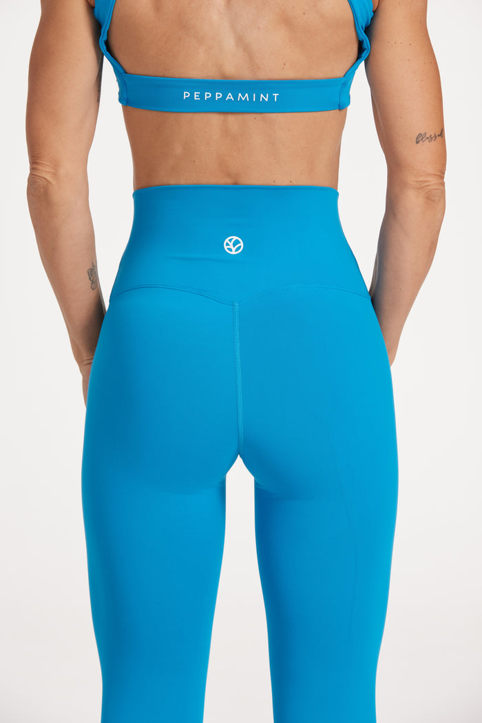 high waisted buttery soft, supportive activewear tights, with no front rise seam in blue coral