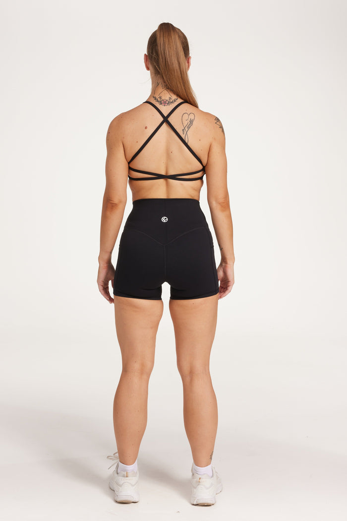 high waisted 4" inseam activewear shorts with 2 pockets, no front rise seam, in a buttery soft, supportive fabric with twist bra and cross back straps