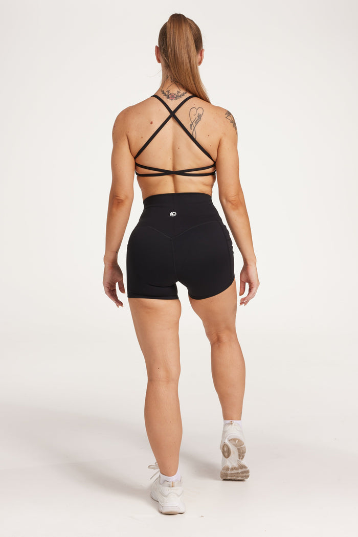 high waisted 4" inseam activewear shorts with 2 pockets, no front rise seam, in a buttery soft, supportive fabric with twist bra and cross back straps