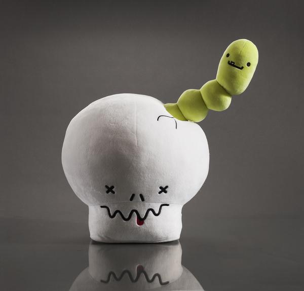 Interactive plush toy featuring a giant skull and worm from Kidrobot's BFFs collection, soft and detailed plush design by Travis Cain