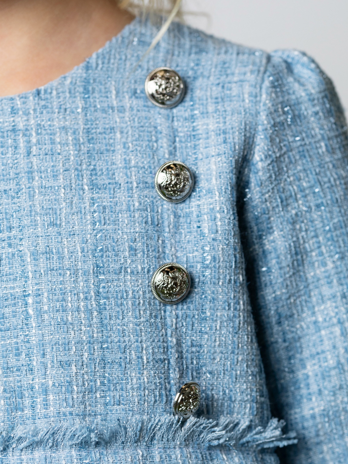Gold button detail on girls blue graduation dress