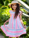 girl wearing pastel stripe summer dress with tassel detail