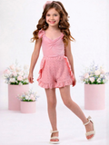 Girl wearing coral eyelet short set with ruffle shorts for spring outfit