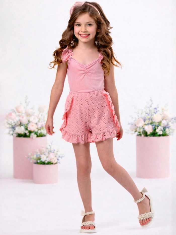 Girl wearing coral eyelet short set with ruffle shorts for spring outfit