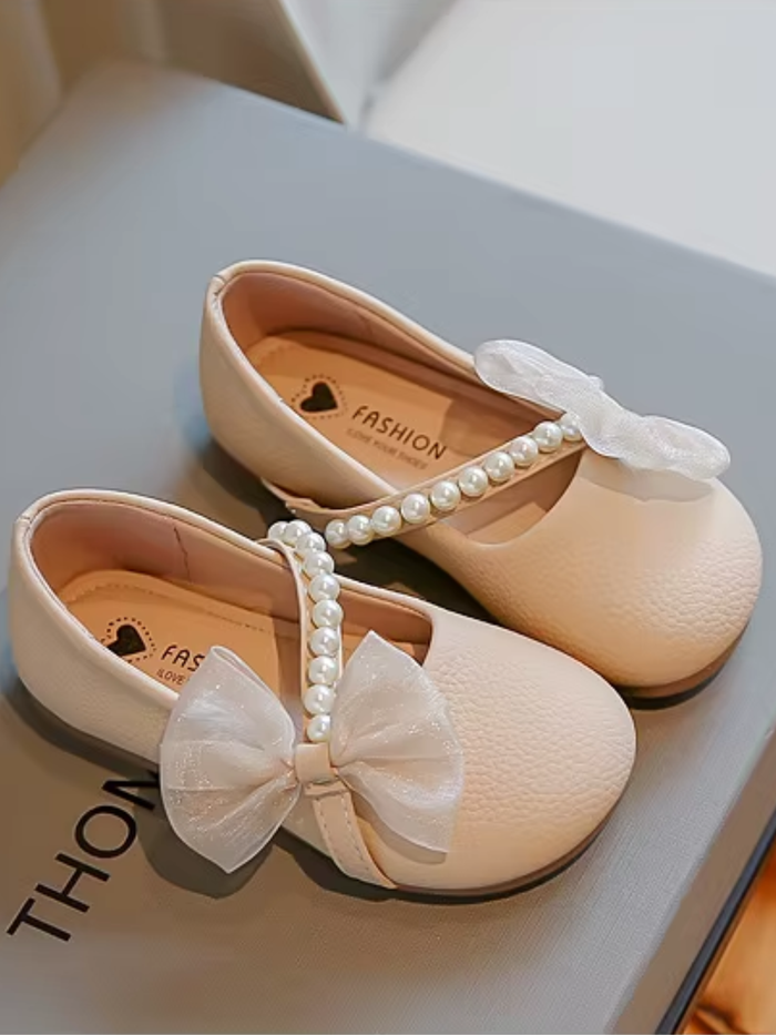 beige girls dress flats with pearl strap and bow detail