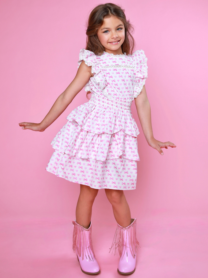 Girls pink bow print smocked dress with ruffle sleeves and tiered skirt