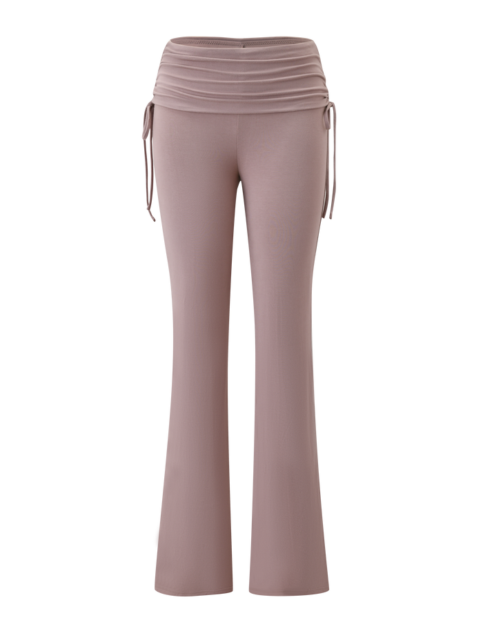 The TIGERMIST HALONA PANT - MOCHA features a high waist, flared silhouette, ruched waistband, and adjustable side ties in a light mauve mocha shade, shown against a white background.