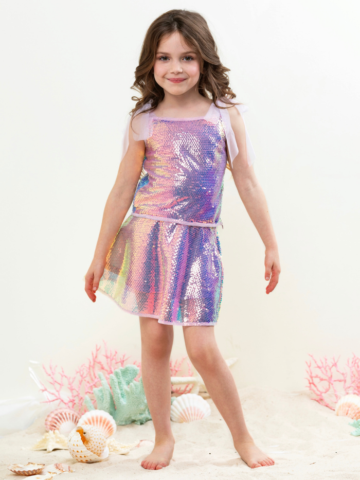 Girl wearing iridescent sequin skirt set with shimmer top for party outfit