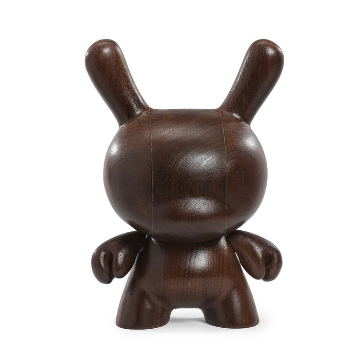 Limited edition Kidrobot RAW Black Walnut 8-inch wood Dunny toy with natural wood grain finish and detailed sculpting.