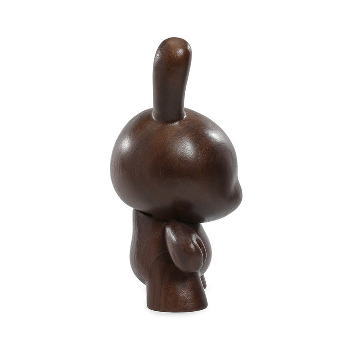 Limited edition Kidrobot RAW Black Walnut 8-inch wooden Dunny figure, showcasing detailed craftsmanship and natural wood grain.