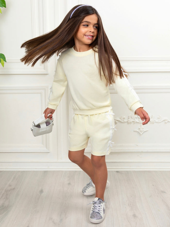 Yellow girls matching outfit featuring lace trim and ribbon bows