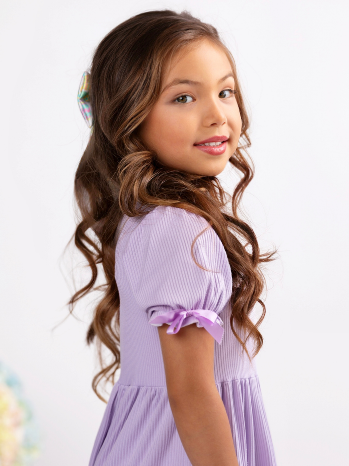 Girl wearing purple ribbed dress with flowy skirt for Easter outfit