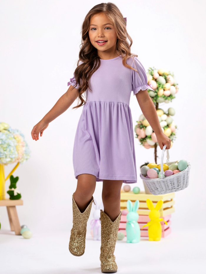 Little girl in lavender short sleeve dress with satin bow details