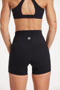 Buttery soft high waisted women's gym shorts with 4" inseam with curved stitched detailing for a butt shaping effect, and no front rise seam, paired with a high neck women's sports bra with a supportive elasticated hem and triple layered fabric with removable pads for extra support and crossover back straps in Black.
