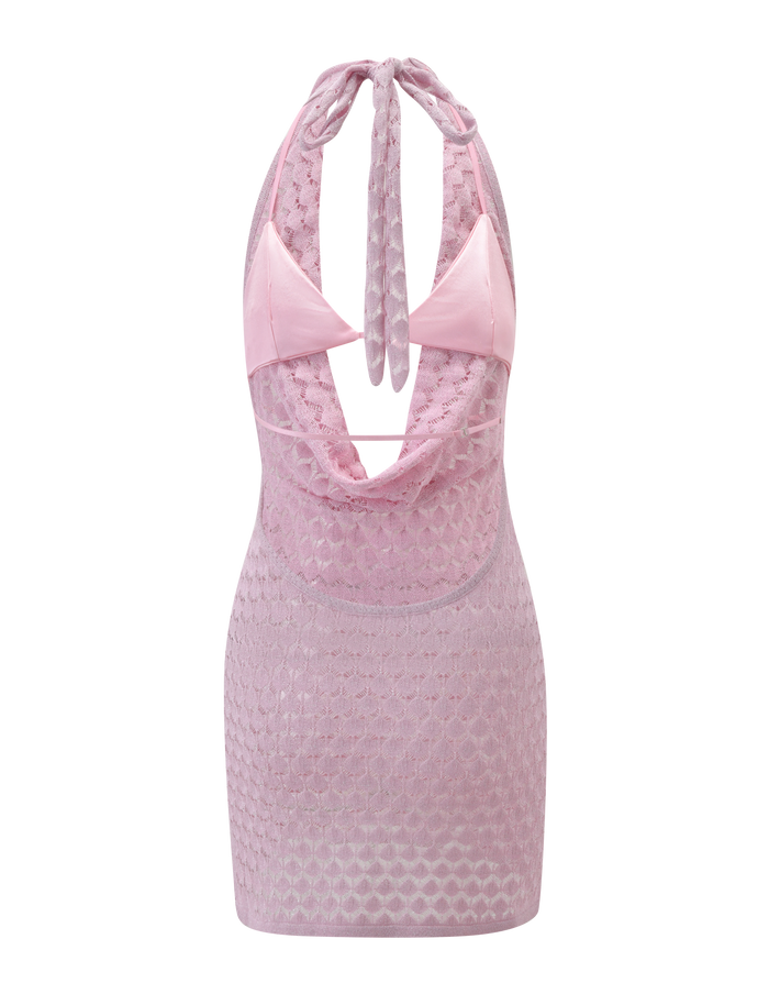 The MAKENZIE CROCHET MINI DRESS - SHIMMER PINK by TIGERMIST is a sleeveless mini dress featuring a light pink shimmer crochet design, sheer textured overlay, cowl neckline, adjustable tie halter neck, and open back.