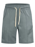 Green shorts with a drawstring on a white background