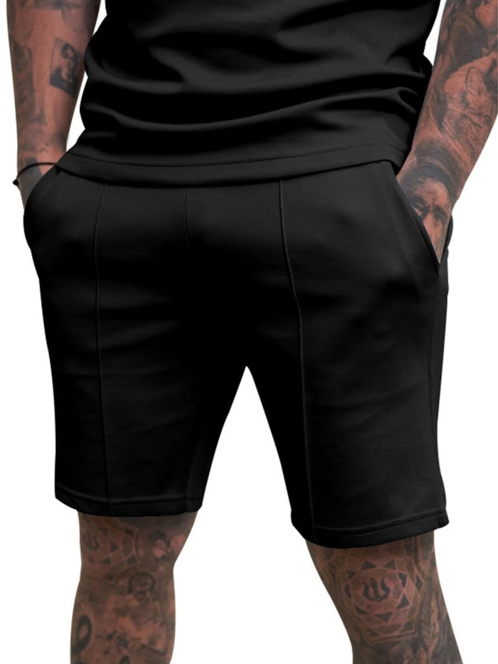 Person wearing black shorts on a white background