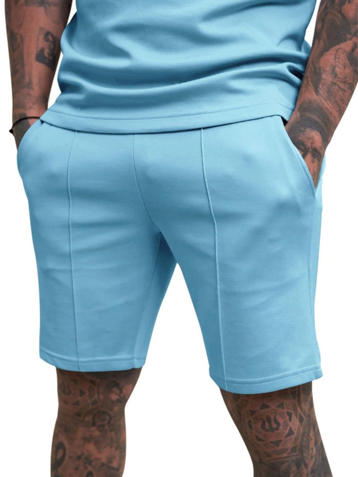 Light blue shorts worn by a person with tattoos on a white background