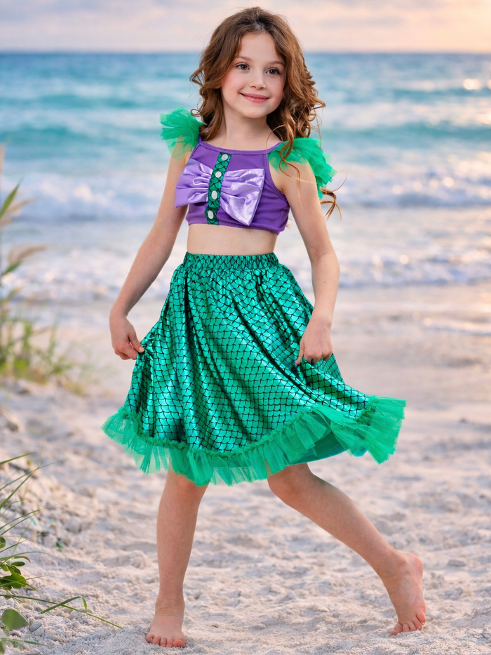 Little girl in purple top and green shimmer skirt outfit for summer