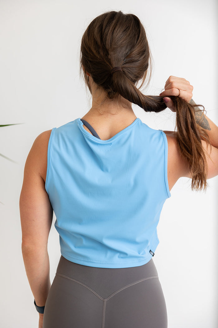 buttery soft crop length tank top in baby blue with subtle stitched logo tag