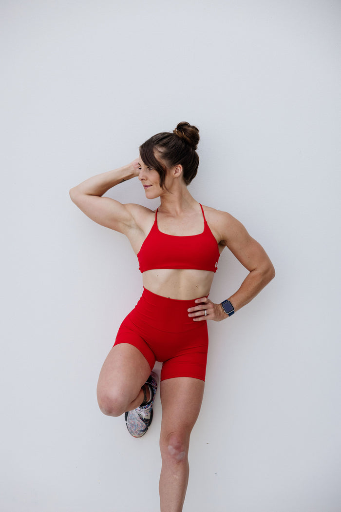 buttery soft sports bra with spaghetti straps and cross back strap design in scarlet red