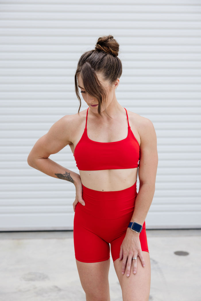 buttery soft sports bra with spaghetti straps and cross back strap design in scarlet red