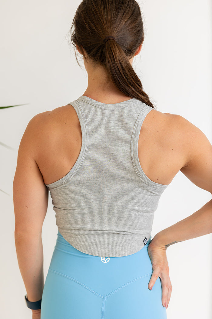 ribbed crop top in grey marl with curved edge hem and subtle logo stitched tag