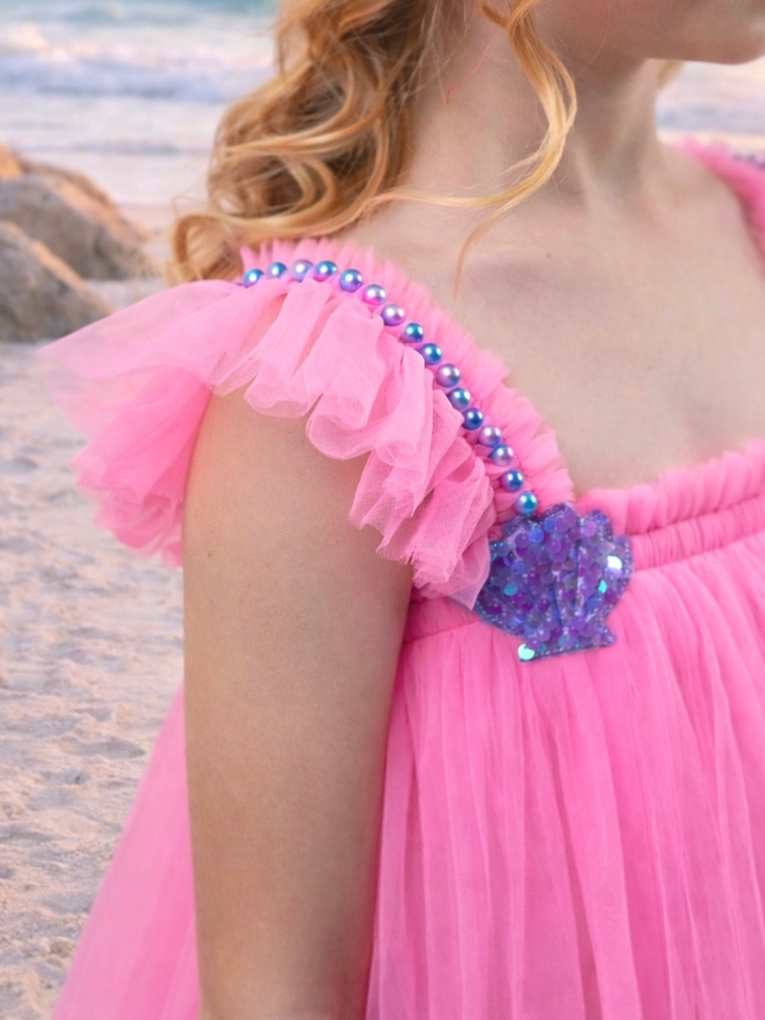 Little girl in pink tulle party dress with flowy skirt