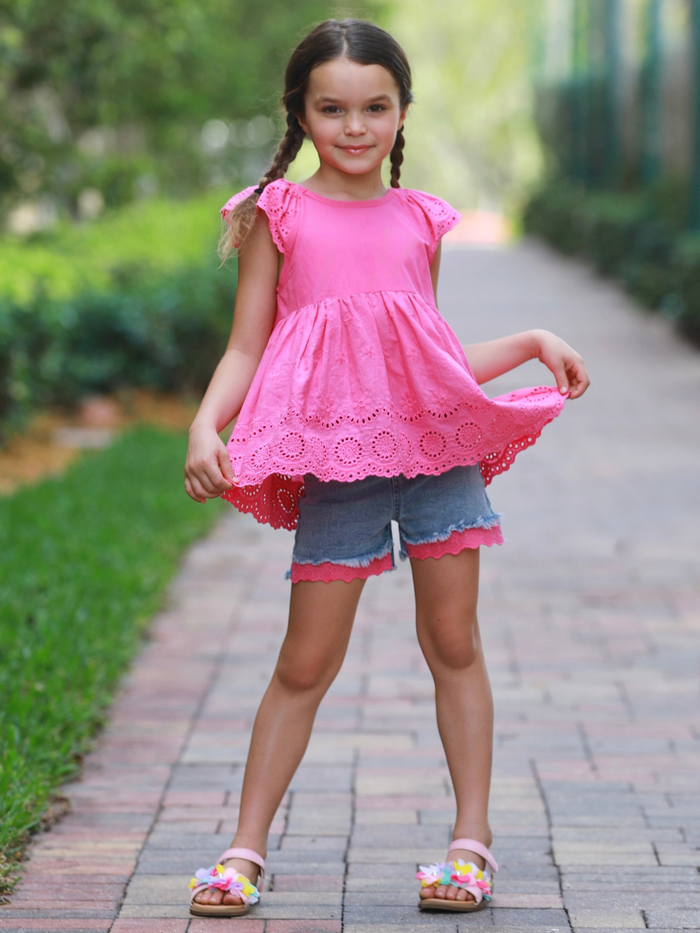 girl wearing pink eyelet top with denim shorts summer outfit