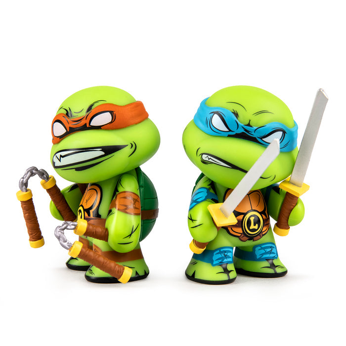 Teenage Mutant Ninja Turtles 3-inch vinyl figures of Leonardo and Michelangelo in a 2-pack, featuring detailed character designs.