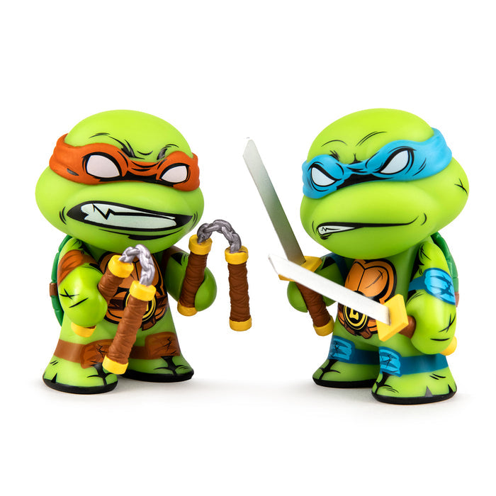 Teenage Mutant Ninja Turtles Leonardo and Michelangelo 3-inch vinyl figures in a 2-pack, detailed mini figures for fans.