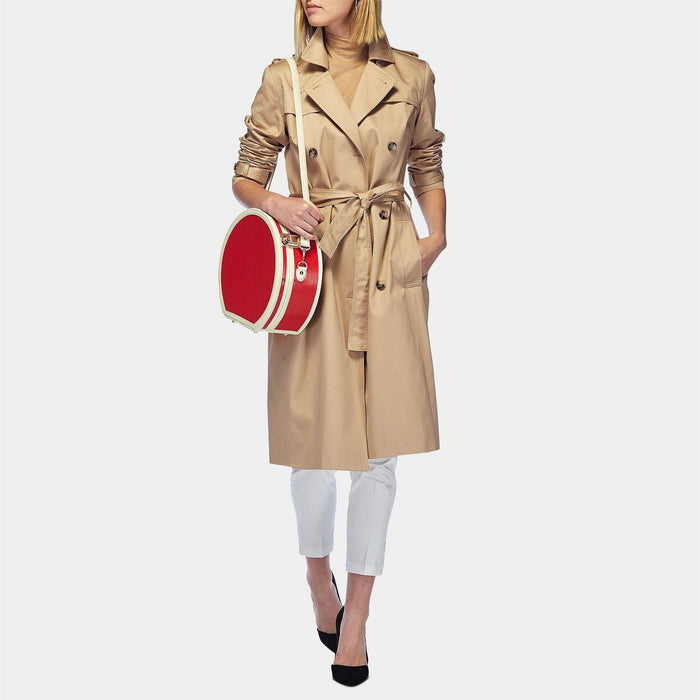 Model with the small hatbox Entrepreneur vegan leather suitcase in lipstick red with shoulder attachment strap