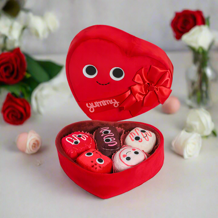 Yummy World Amore plush toy resembling a heart-shaped box of chocolates with interactive features, soft and colorful plush.